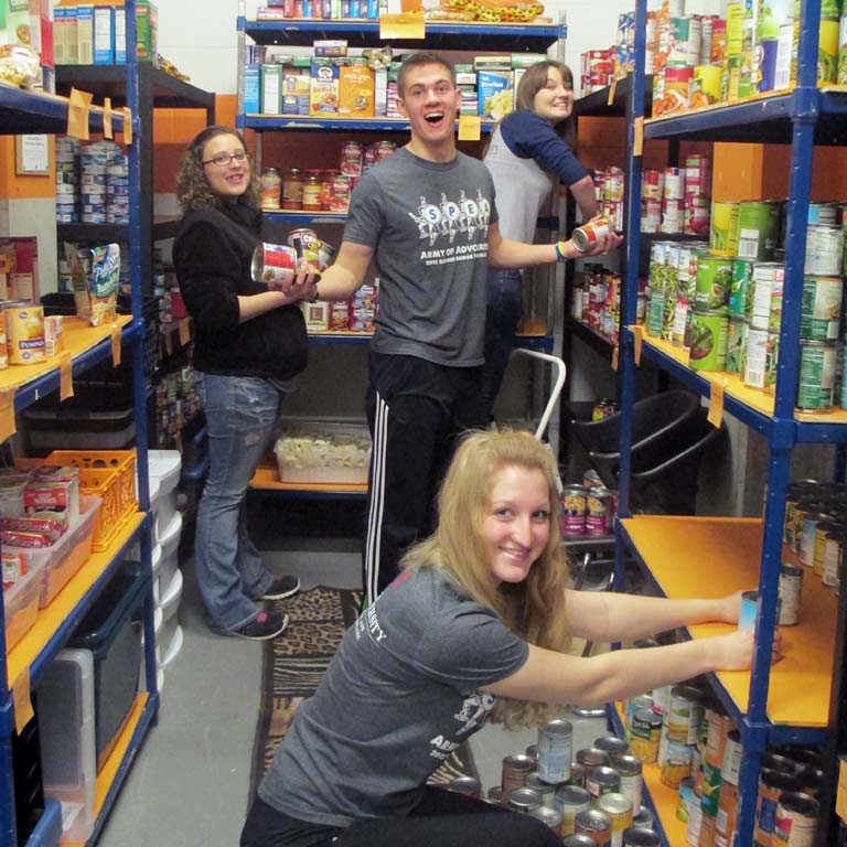 Student volunteers stock a food bank.