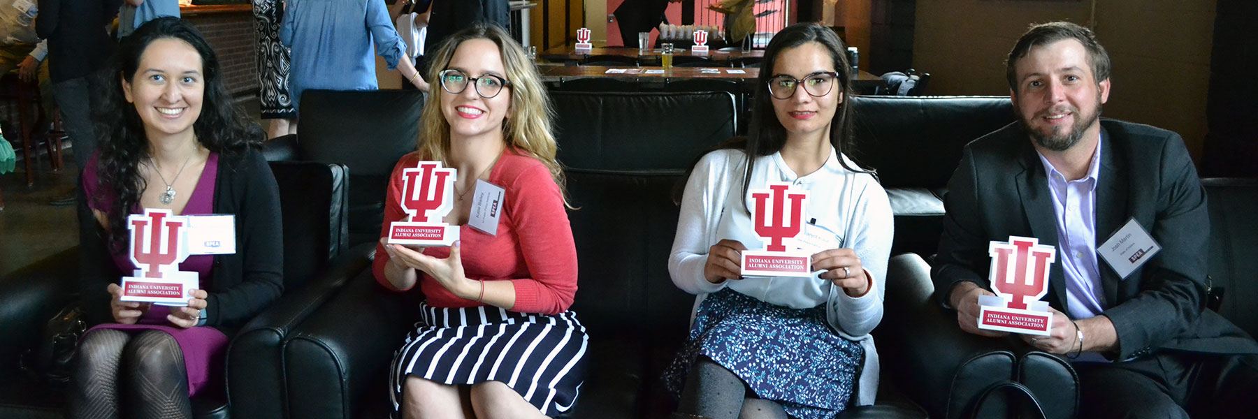 SPEA Alumni Association members smile and hold IU trident placards.